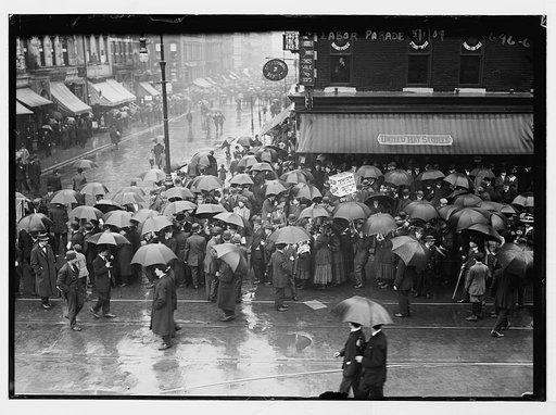Labor Day (May Day) parade, crowd in rain in street, New York