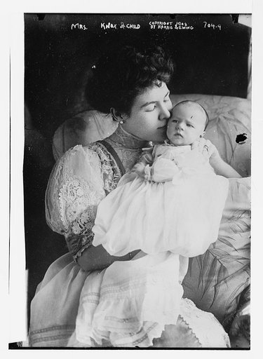 Mrs. Knox holding her baby, Harris & Ewing