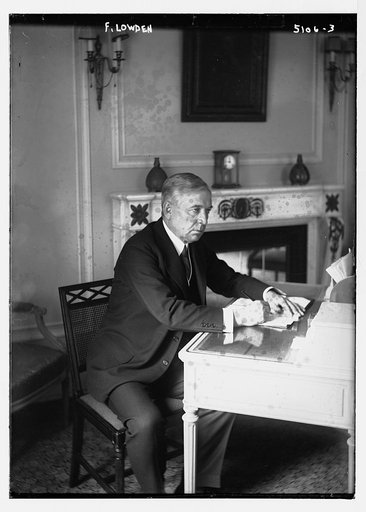 F. Lowden, seated at desk, writing