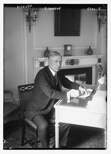 F. Lowden, seated at desk, writing