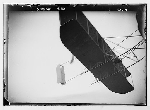 O. Wright and aeroplane, in flight