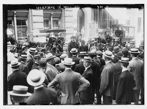 Rev. Dame speaking to crowd on Wall St., New York