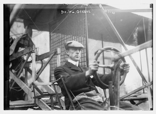 Dr. W. Greene, at pilot wheel of aeroplane
