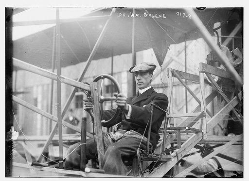 Dr. Wm. Greene at pilot wheel of aeroplane