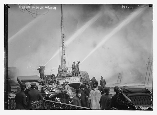 Firemen and equipment used against burning building on 14th St., New York