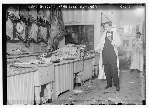 Butcher stands idle before his counter of meat during the meat boycott
