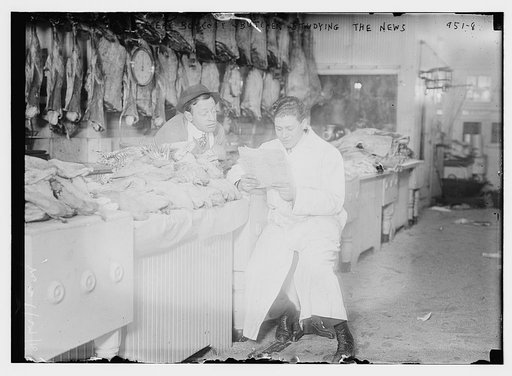 Butchers read newspaper at the counter full of meat during meat boycott