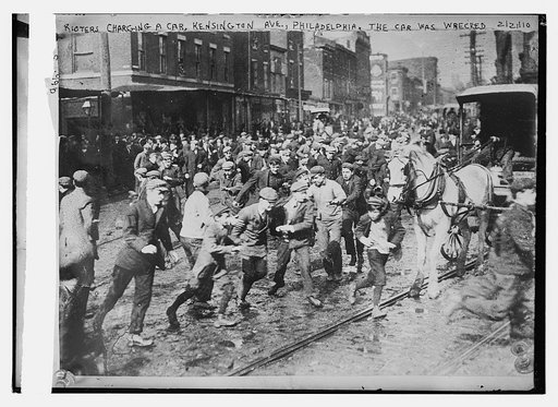 Rioters charging horse-drawn car, later wrecking it on Kensington Ave., Philadelphia