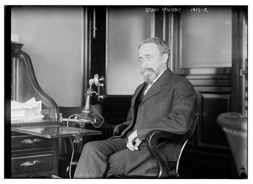 Starr Murphy seated at desk with telephone