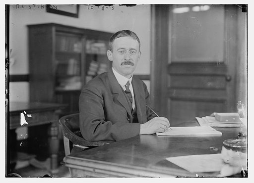 H.L. Stimson at desk