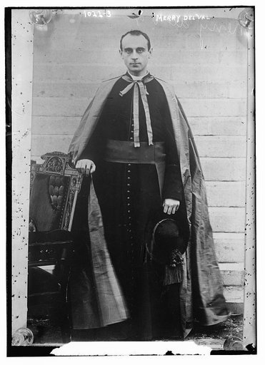 Merry Del Val standing beside chair