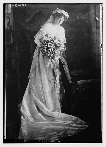 Mrs. Harold J. Ellsworth holding bouquet