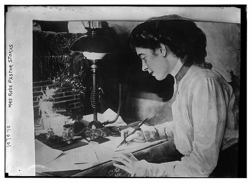 Mrs. Rose Pastor Stokes at desk writing