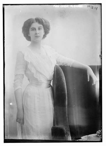 Miss Jessie M. Drake standing by chair