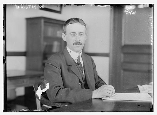 H.L. Stimson at desk writing