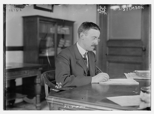 H.L. Stimson at desk writing