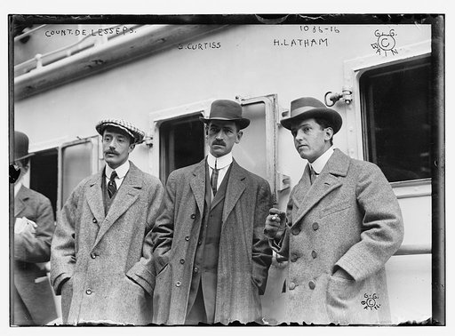 Count de Lesseps, G. Curtiss, and H. Latham standing on train platform