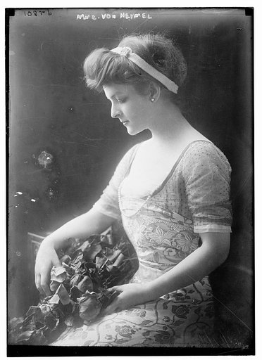 Mme. Von Heymel seated holing flowers