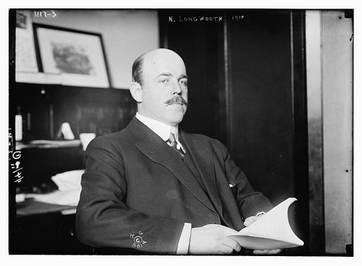 N. Longworth seated with book