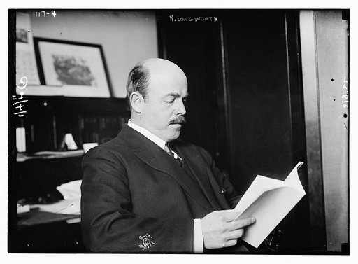 N. Longworth seated with book