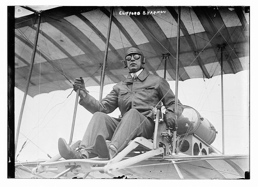 Clifford B. Harmon. Seated in airplane.