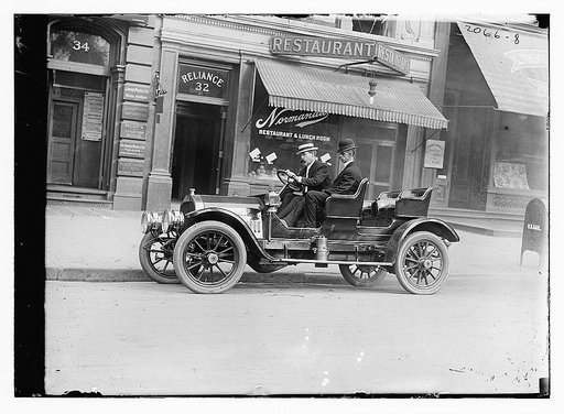 G.G. Bain in auto in front of restaurant #32 (#34 Japan Paper Co.)