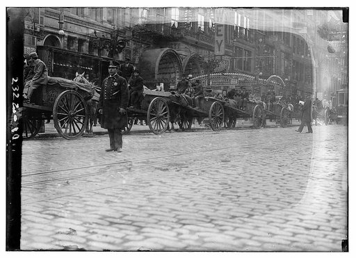 Garbage carts protected by police during a strike, New York City