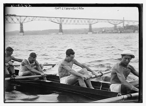 Stanford University crew rowing on Hudson River with Poughkeepsie Bridge, New York, in background