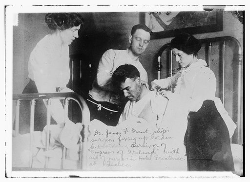 Dr. James F. Grant, ship's surgeon, fixing up Gordon G. Davidson, survivor of EMPRESS OF IRELAND, in Hotel Frontenac at Quebec
