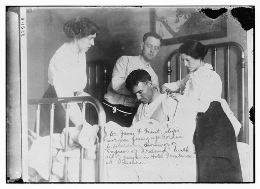 Dr. James F. Grant, ships surgeon, fixing up Gordan C. Davidson, survivor of EMPRESS OF IRELAND, with aid of nurses in Hotel Frontenac at Quebec