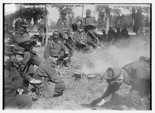 French soldiers eating soup on march