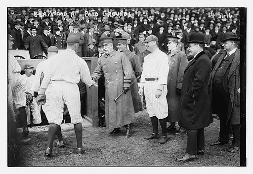 General Leonard Wood shakes hands with a Yankee baseball player as Yankees Manager Bill Donovan stands to the right of him, Polo Grounds, New York (baseball)