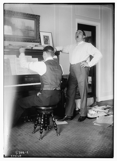 Burke [standing near piano - singing
