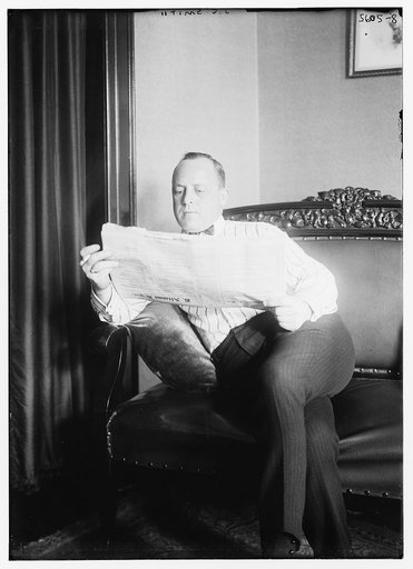 J.C. Smith [reading newspaper