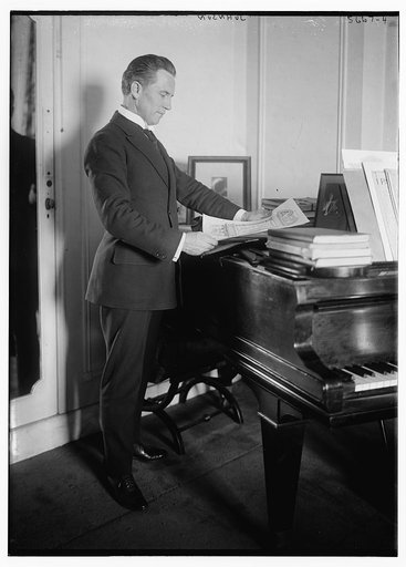 Johnson [standing near piano