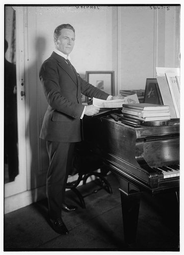 Johnson [standing near piano