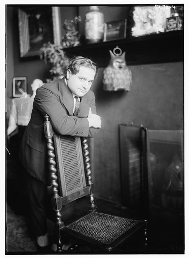 Beniamino Gigli near chair