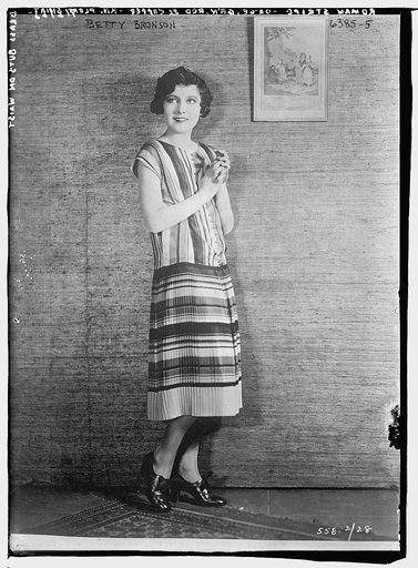 Betty Bronson modeling Roman Stripe -- Orange, Green, Red & Copper Knit Pleated Skirt with Brass Buttons