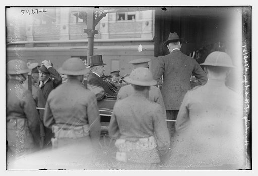 Warren G. Harding and wife riding in back of car