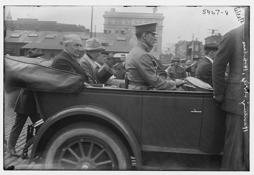 President Warren G. Harding and his wife riding in back of car