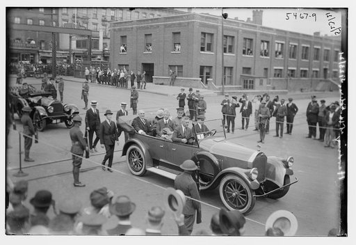 Car with Warren G. Harding driving through procession