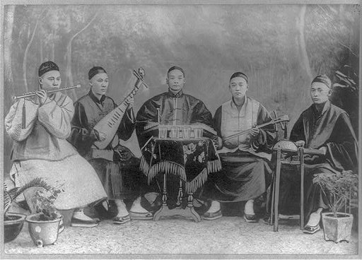 5 Chinese musicians playing flute, 2-stringed fiddle, 3-stringed psaltery, drums, and small bells