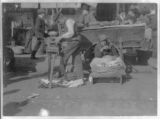 New York City street peddler; man sharpening saws and woman selling peanuts, Hester and Norfolk Streets