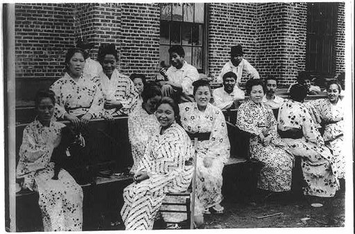 Japanese women and men sitting on benches, Hawaii