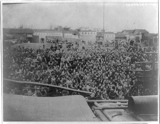 China, Changsha; mass of people at waterfront, view across boat
