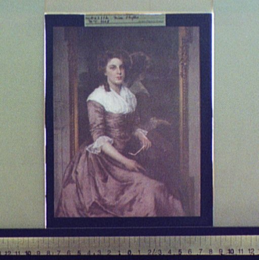 Unidentified woman sitting in front of mirror, full-length portrait