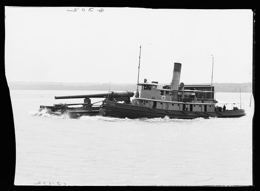 Tugboat USS Tecumseh with barge carrying cannon