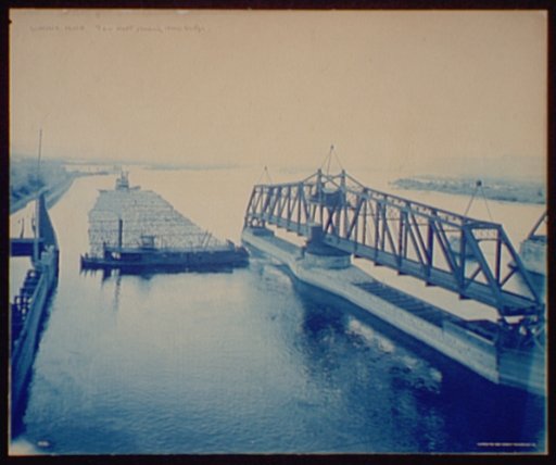 Winona, Minn., tow raft passing drawbridge