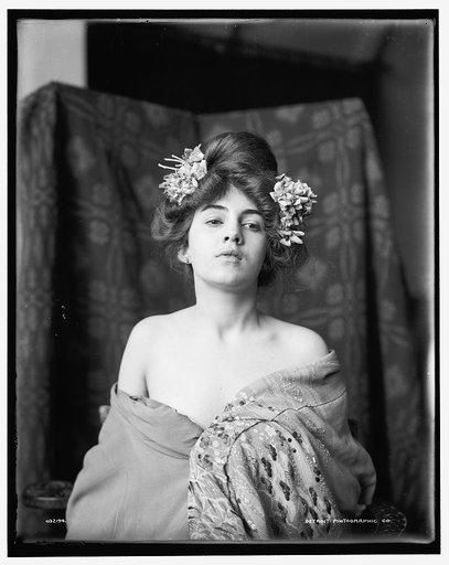 Model, flowers in hair, head level