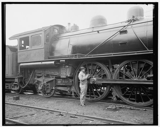 Railroad engineer oiling up before the start